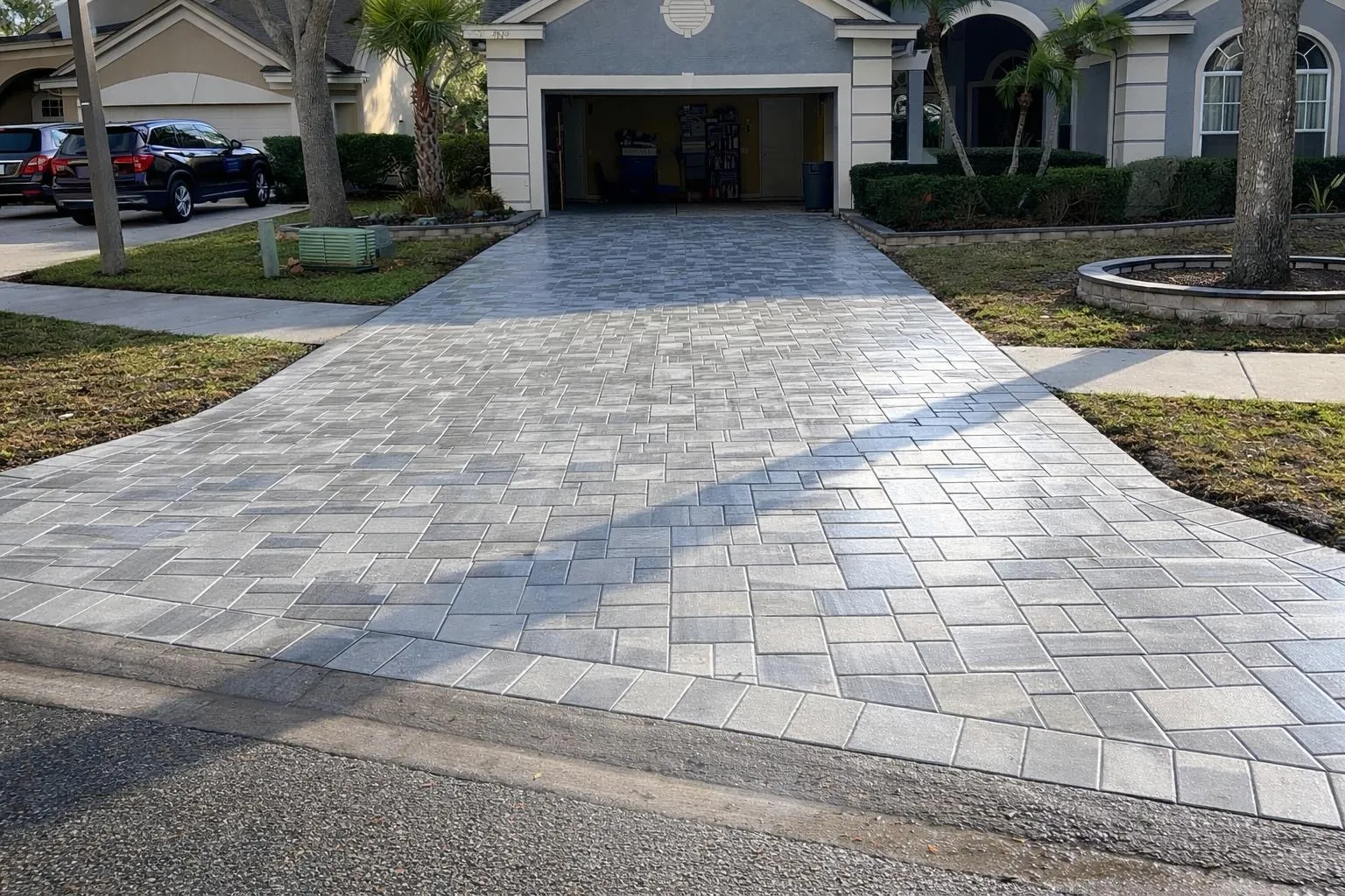 Cracked concrete driveway replaced with gray pavers
